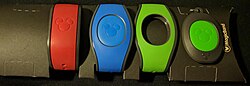 Three wristbands and a key fob on a black background