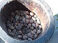 Korarima fruits in a mortar, ready to be crushed .