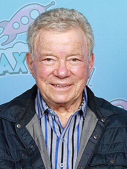 Headshot of William Shatner at GalaxyCon in Richmond in 2026. He is a later-aged, clean-shaven, light-skinned man with grey hair. He is wearing a button-up shirt and a jacket on top.