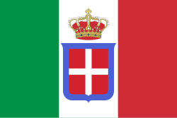 The flag of the Kingdom of Italy, a vertical tricolour of green, white, and red. The white stripe contains a coat of arms depicting the crown of the Italian monarchy atop a red shield, outlined in blue, with a white cross in the center.