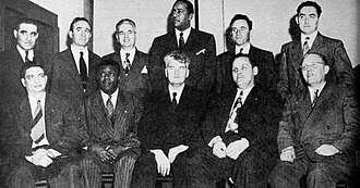 Eleven well-dressed men, seated for a formal photograph.