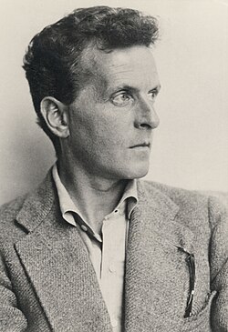 Photo of a man with short hair wearing a suit