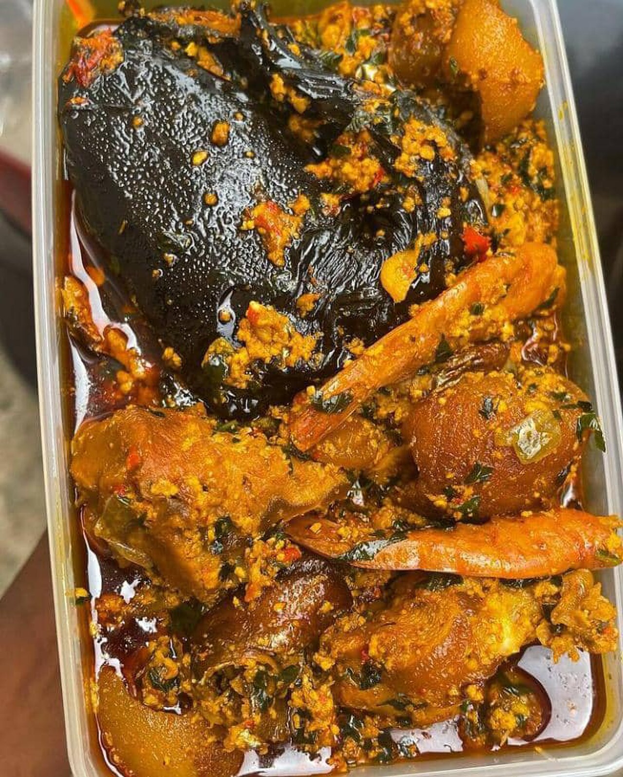 Egusi soup with vegetables and dried catfish, prawns, beef and roasted cowskin.jpg