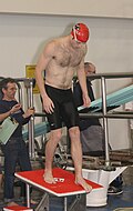 A man on a diving board wearing a jammer