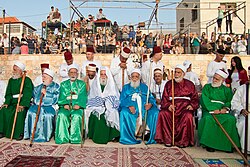 Samaritan High Priest surrounded by other priests in ornate colors; they all have canes or staffs
