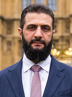 Syrian president Ahmed al-Sharaa with a large beard and moustache