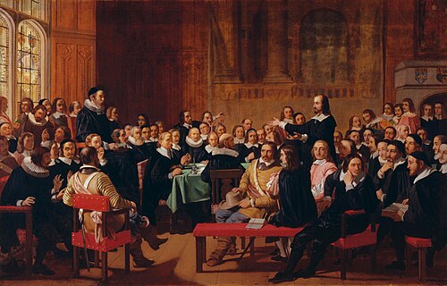 A painting of the Westminster Assembly in session. Philip Nye is standing and gesturing. Various figures are seated around a table. Prolocutor William Twisse is seated on a raised platform.