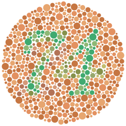 The number "74" – composed of scattered solid circles of varying size and varying but approximately green color – surrounded by a field of approximately sandy brown circles also of varying size and color. Some of the color variation in the circles is deliberately curated such that viewers with red-green color blindness will likely see the number "21" instead of "74".