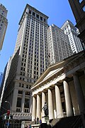 Federal Hall, once the U.S. Custom House, now a museum, with the towers of Wall Street behind it