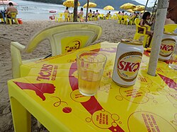 Skol cans and tables at the beach in Brazil