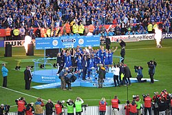 UCFB alumni Wes Morgan lifting the Premier League trophy as captain of Leicester City F.C.
