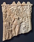 Plaque with female figure dressed in ancient variation of sari, 1st century BCE