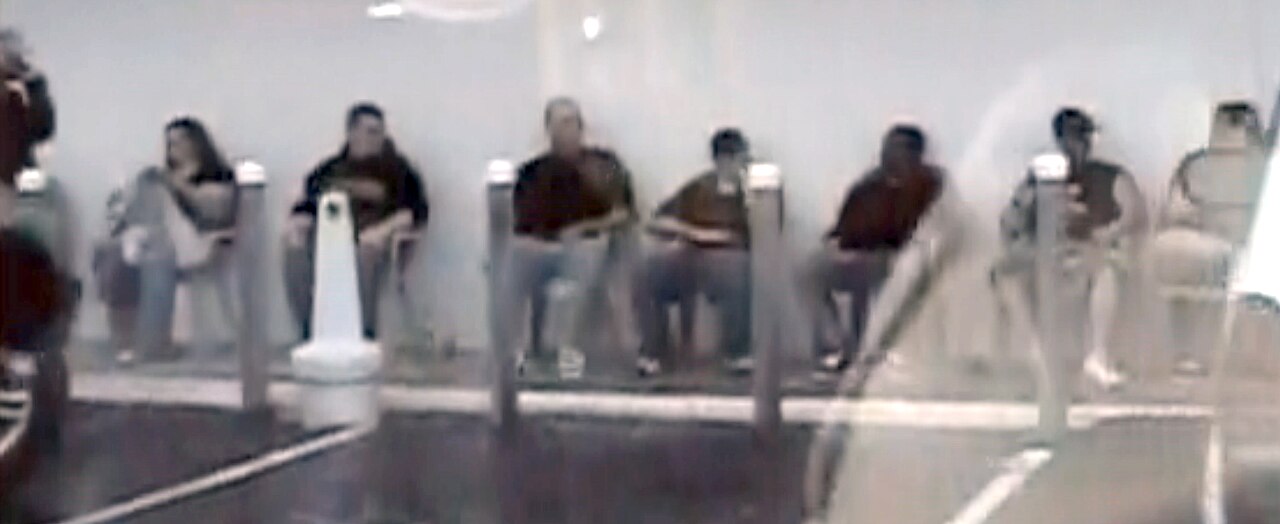Customers of a Florida pill mill run by Jeff and Chris George wait in chairs on the sidewalk.jpg