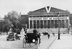 A German V-sign and slogan on the Palais Bourbon, the seat of the French Parliament, in occupied Paris. The banner beneath the "V" reads "Germany is Victorious on All Fronts".