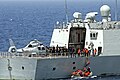 Aft-deck of frigate Yiyang (548) with PLAN and USN personnel, and a Harbin Z-9 helicopter