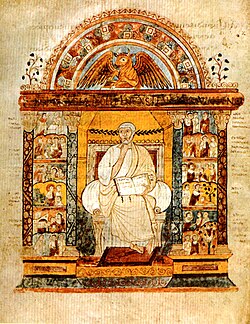 An illuminated manuscript illustration of a central seated figure holding an open book. He is flanked by two colonnades filled with small scenes. Over the central figure is an arch which surmounts a winged bull.