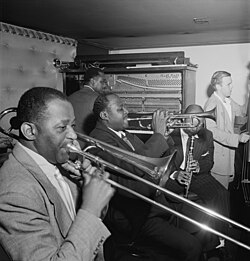 Price (background) with Wilbur De Paris (left), Sidney De Paris, Eddie Barefield and Charlie Traeger, Jimmy Ryan's (Club), New York, c. July 1947. Photograph by William P. Gottlieb.