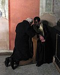 A penitent confessing his sins in the Ukrainian Greek Catholic Church of the Bernardines in Lviv, Ukraine