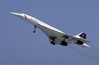 Concorde against a blue sky, seen from below. Its wheels are lowered.