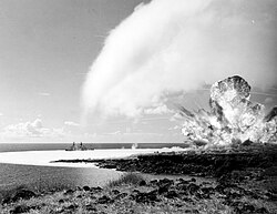 Detonation of the 500-ton TNT explosive charge as part of Operation Sailor Hat in 1965. The passing blast-wave left a white water surface behind and a white condensation cloud is visible overhead.