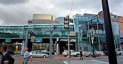 A side view of a glass-covered elevated railway station