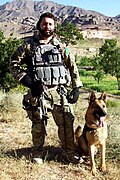 A U.S. Air Force Security Forces dog handler attached to the Army's 3rd Special Forces Group in Afghanistan with a German Shepherd