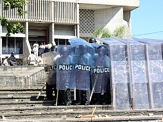 Riot police using riot shields in testudo formation during the 2005 Belize unrest