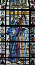 St. Faustina, wearing the habit and veil of the Congregation of the Sisters of Our Lady of Mercy and a crucifix necklace, holds her diary, as rays of light descend from heaven.