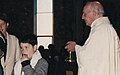 Boy receiving Holy Communion which a Catholic is refused if their soul is not in a state of Grace
