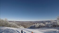 A photograph of the view form the North Face trail on Plattekill Mountain with snow visible