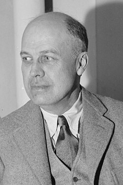 Black-and-white photo of Edward Hopper in 1937, seated and facing left