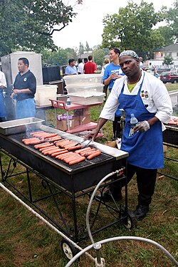 Hot dogs being grilled outside
