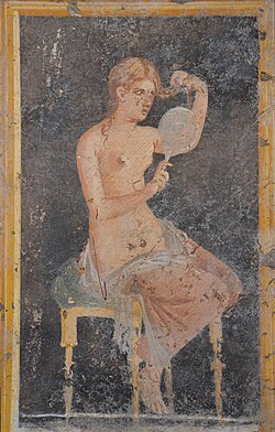 Fresco showing a woman looking in a mirror as she dresses (or undresses) her hair, from the Villa of Arianna at Stabiae (Castellammare di Stabia), Naples National Archaeological Museum
