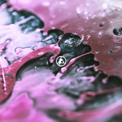 The band's symbol rests small, dead center over an artistic macro shot with a high depth-of-field, presented abstractly like flowing liquid