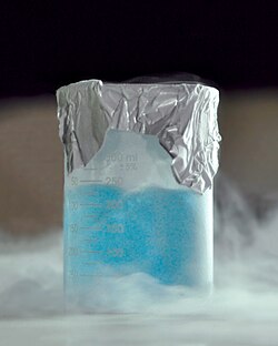 A pale blue liquid, with visible boiling