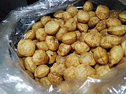 A pile of small puris with dark, coarse appearance