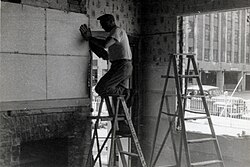 Arthur Barbezat removing Red Jacket mural from wall