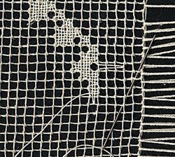Filet lace embroidered on an existing net