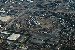 Aerial view of a horse racing track and surrounding facilities