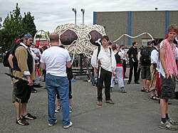 various people standing around a small Flying Spaghetti Monster Parade float.