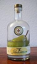 Poire Williams, a fruit brandy produced from the Williams pear. The bottle is tied to the tree and the pear is grown inside it.