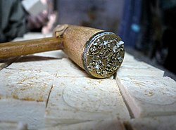 Al Khatimeh or the stampers hand-stamp each soap bar with its brand logo.[22] Photo at the Shaka'a factory.