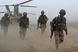 DBDU-clad Spanish soldiers disembark from a CH-47 Chinook helicopter in Afghanistan, September 2008.