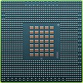 The underside of the 90 nm Cell/B.E. processor showing its 1242 solder balls, each 0.6 mm in diameter, and its array of 35 capacitors