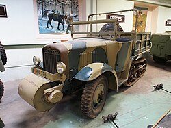 Photo of Unic P107 museum specimen from front-left. The wide cylindrical roller is mounted at front below the radiator grill.