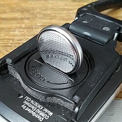 Coin slot-style screw head on a battery holder, capable of being opened using the CR2032 battery.