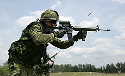 Canadian soldier firing a C7A2 rifle fitted with a C79A2 optical sight.