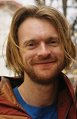 O'Connell facing head on to the camera with a slightly parted lip smile