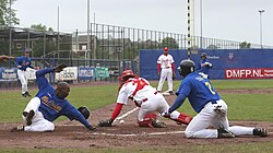 A catcher for Kinheim (wearing red) attempting to tag out a HCAW player (wearing blue) at home plate during a 2007 game