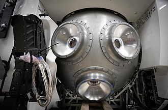 The titanium pressure hull during construction, with the acrylic viewports installed and the manipulator arm partly installed.